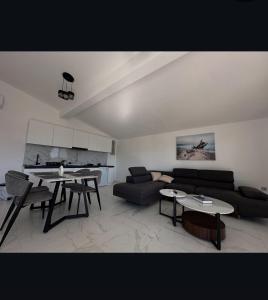 a living room with a couch and a table at Martin Apartments in Gornji Štoj +2 photos