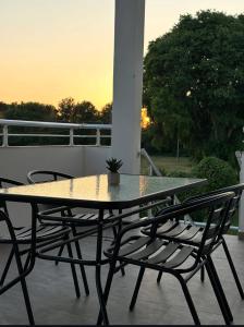 a table and chairs on a patio with the sunset at Martin Apartments in Gornji Štoj