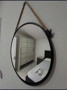 a mirror hanging on a wall with a bed in a room at Martin Apartments in Gornji Štoj