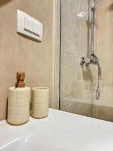 a bathroom with a shower and two soap dispensers on a sink at Adriatic Retreat Mljet in Polače +51 photos
