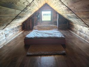 a bedroom with two beds in a wooden cabin at Słoneczne Łąki in Wólka Soseńska