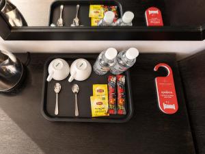 a tray with utensils and other items on a counter at Champs Elysees Boutique Hotel in Phumĭ Réach Born (2)