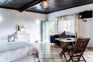 a bedroom with a bed and a table and chairs at Gillys Accommodation in Camperdown +85 photos