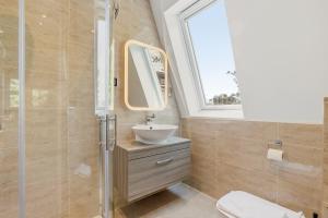 a bathroom with a sink and a mirror at London Star Hotel in London