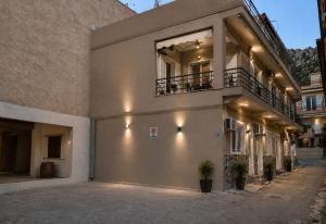 a building with a garage with two balconies on it at Domenica apartment in Salamina