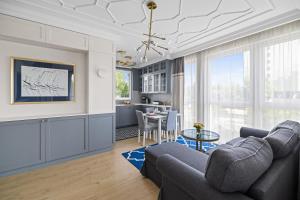 a living room with a couch and a table at INA Rent - Tre Mare Apartamenty in Gdańsk