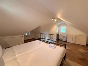 a bedroom with a large white bed in a attic at Villa Mala Dora in Stari Grad +19 photos