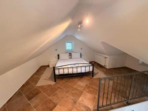 a attic bedroom with a bed and a staircase at Villa Mala Dora in Stari Grad
