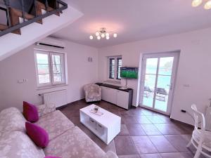 a living room with a couch and a table at Villa Mala Dora in Stari Grad