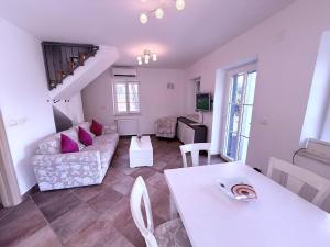 a living room with a couch and a table at Villa Mala Dora in Stari Grad