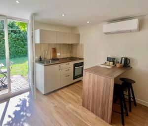 a kitchen with a counter and a sink and a stove at Petit Lodge in Pierrevert +10 photos