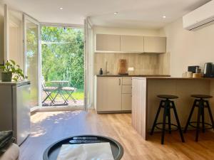 a kitchen with a table and some stools in it at Petit Lodge in Pierrevert
