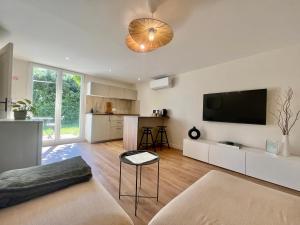 a living room with a flat screen tv on the wall at Petit Lodge in Pierrevert