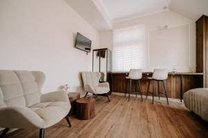 a living room with white chairs and a table at Diamond Boutique Hotel in Pruszcz Gdański