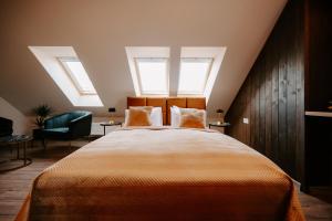 a bedroom with a large bed with two windows at Diamond Boutique Hotel in Pruszcz Gdański
