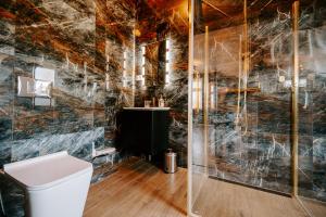 a bathroom with a toilet and a glass shower at Diamond Boutique Hotel in Pruszcz Gdański +58 photos
