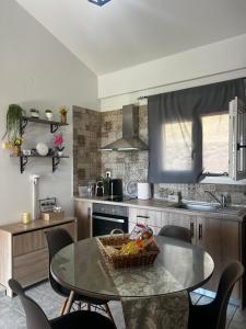 a kitchen with a table with a basket of fruit on it at To Balkoni Thanos in Thános +15 photos