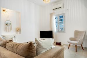 a living room with a couch and a chair at Consolato House in Patmos