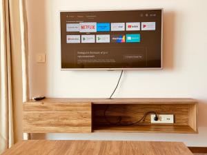 a flat screen tv sitting on a wall at Skyline View Apt & Sea View Terrace in Budva