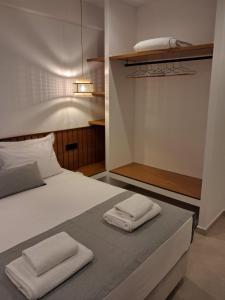 a bedroom with a bed with two towels on it at Salsedo Seaside Rooms 3 in Kanali