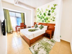 a bedroom with a bed and a painting on the wall at The Kyaka Hotel in Machakos +31 photos