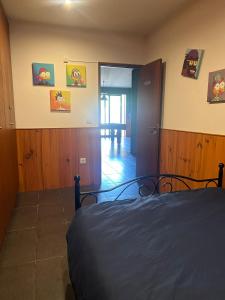 a bedroom with a bed and a door to a hallway at Villa Ouro Verde in Gondomar