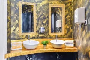 a bathroom with two sinks and two mirrors at Brothers House in Arrecife
