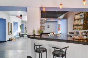 a kitchen with four stools at a counter with a bar at Brothers House in Arrecife +22 photos