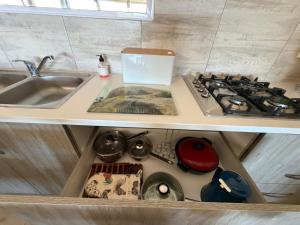 a kitchen drawer with a stove and a sink at Karibu Self-Catering Unit 1 in Omaruru +74 photos