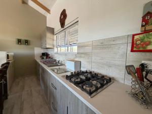 a kitchen with a stove top oven next to a counter at Karibu Self-Catering Unit 1 in Omaruru