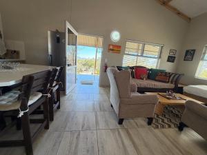a kitchen and living room with a table and a couch at Karibu Self-Catering Unit 1 in Omaruru