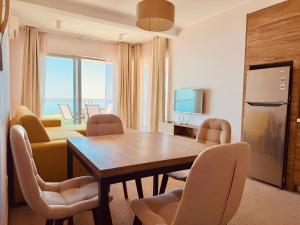 a dining room with a table and chairs at Skyline View Apt & Sea View Terrace in Budva