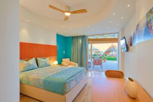 a bedroom with a bed and a ceiling fan at Aptera Beach in Amoudara Herakliou