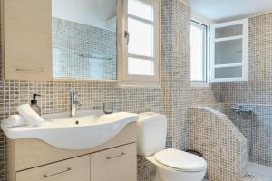 a bathroom with a sink and a toilet at Consolato House in Patmos +22 photos