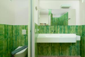 a bathroom with a sink and a toilet at Aptera Beach in Amoudara Herakliou +104 photos