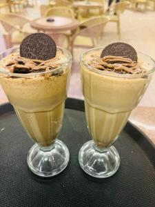 two glasses of chocolate milkshakes sitting on a table at قمه التجلي in Saint Catherine