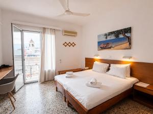 a hotel room with a bed and a desk and a window at Florida Hotel & Apartments - Adults Only in Rhodes Town