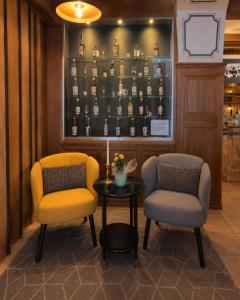 two chairs and a table in a bar at Hotel Sternen Gurtnellen AG in Gurtnellen
