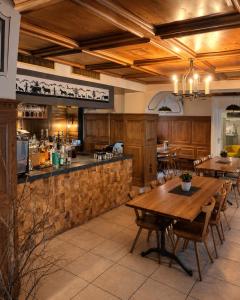 a restaurant with wooden tables and a bar at Hotel Sternen Gurtnellen AG in Gurtnellen