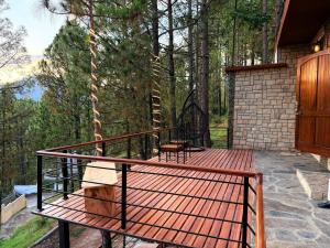 a wooden deck with benches on a house at Highland by Gunner Lodges in Patriata