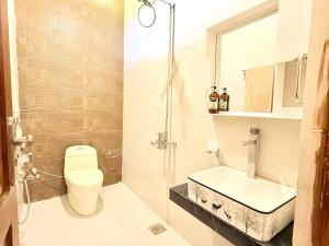 a bathroom with a toilet and a sink at Highland by Gunner Lodges in Patriata +22 photos