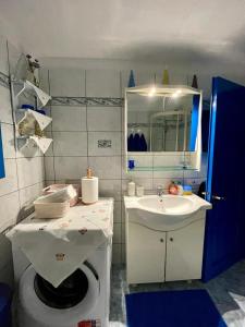 a bathroom with a sink and a toilet at Cycladic House with Aegean Sea View in Aegiali +41 photos