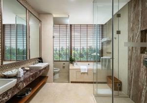 a bathroom with a sink and a toilet and a tub at Yalong Bay Mangrove Tree Resort in Sanya +52 photos