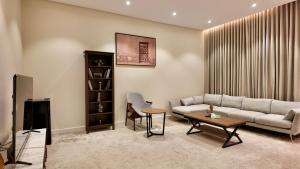 a living room with a couch and a table at نزل ليلى الفندقية الفاخرة luxury in Abha