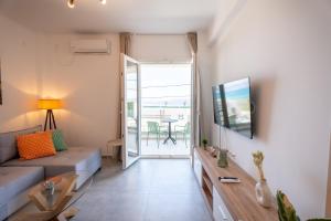 a living room with a couch and a tv at Vrachati Blue in Vrachati