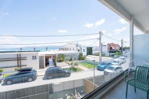 a balcony with cars parked in a parking lot at Vrachati Blue in Vrachati