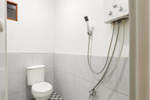 a bathroom with a shower with a toilet at Cozzy Villa TB & Outbond in Riunggunung