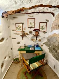 a room with a green desk and a chair at Cycladic House with Aegean Sea View in Aegiali