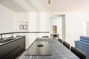 a kitchen with a table with a laptop on it at Lake Como with view, sauna and air conditioning in Mandello del Lario