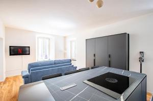 a living room with a blue couch and a table at Lake Como with view, sauna and air conditioning in Mandello del Lario